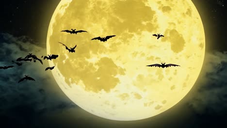 万圣节夜晚金色的月亮下一群飞行的蝙蝠